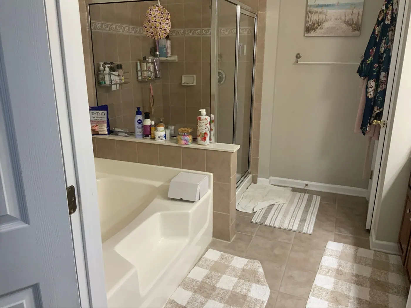 Cluttered drop-in tub and shower combination before remodeling