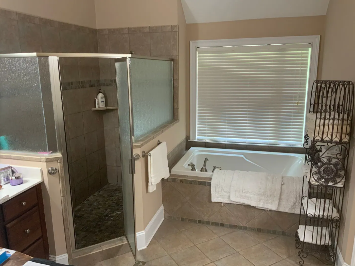 Old garden tub and framed shower enclosure before remodeling