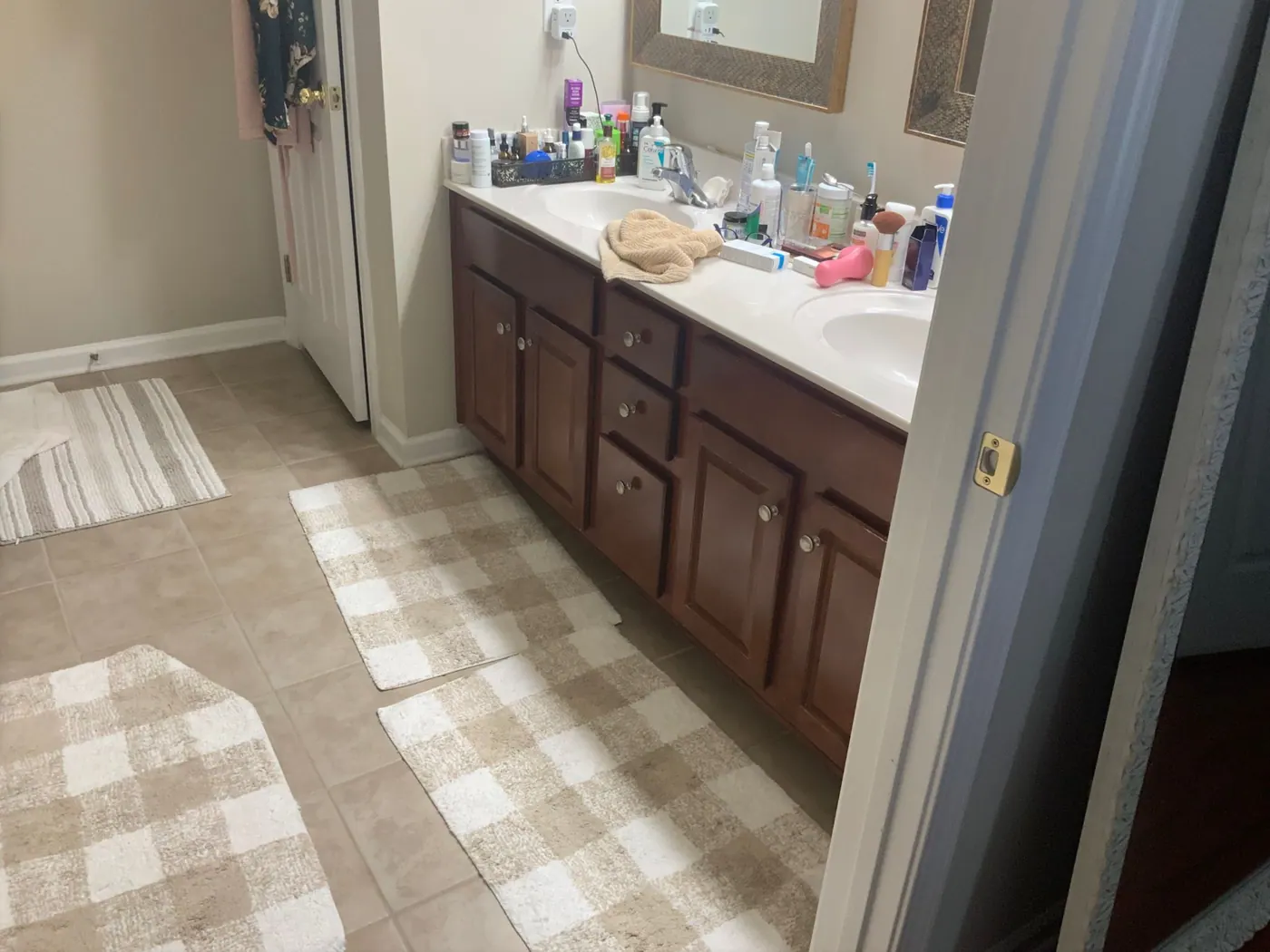 Dark dated double vanity and patterned flooring before remodeling